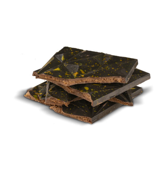 Stacked pieces of dark chocolate bark with a shiny, faceted top surface speckled with yellow accents, on a white back...